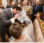 Chosson (groom) placing the veil on the kallah(bride)