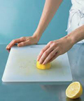 Woman cleaning her cutting board
